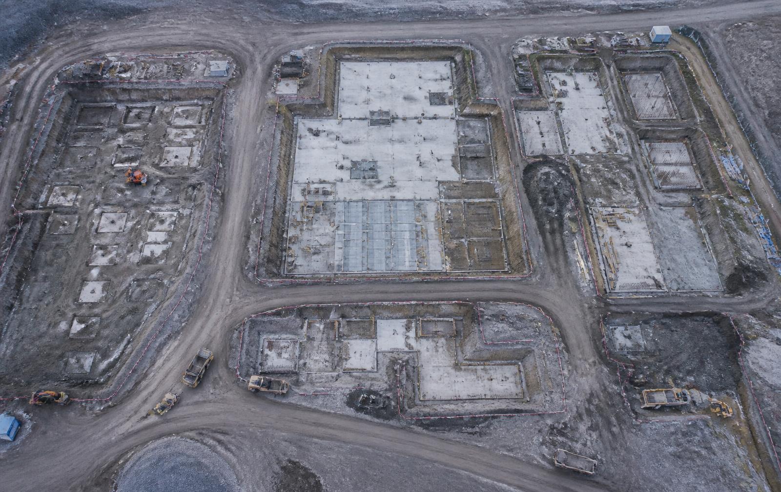 Overhead aerial view of groundworks and foundation slabs on a construction site